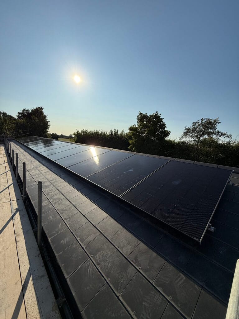 Solar panels on rooftop under bright sun.